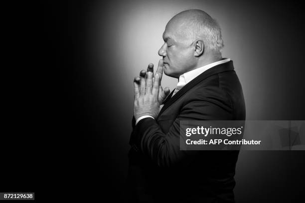 French-Belgian writer Eric-Emmanuel Schmitt poses during a photo session in Paris on November 03, 2017. / AFP PHOTO / JOEL SAGET / BLACK AND WHITE...