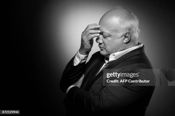 French-Belgian writer Eric-Emmanuel Schmitt poses during a photo session in Paris on November 03, 2017. / AFP PHOTO / JOEL SAGET / BLACK AND WHITE...