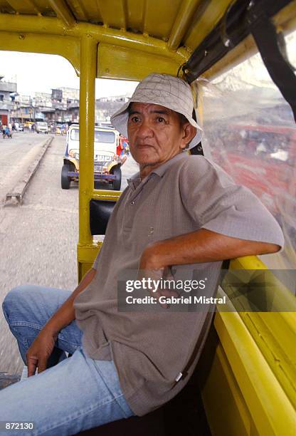 Lijo Castro , a freed hostage who was held by Abu Sayyaf guerrillas for seven months, rides in a jeep to a ferry at Jolo wharf June 29, 2002 on the...