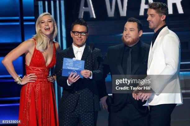 Karlie Kloss, Bobby Bones, Luke Combs, and Brett Young speak during the 51st annual CMA Awards at the Bridgestone Arena on November 8, 2017 in...