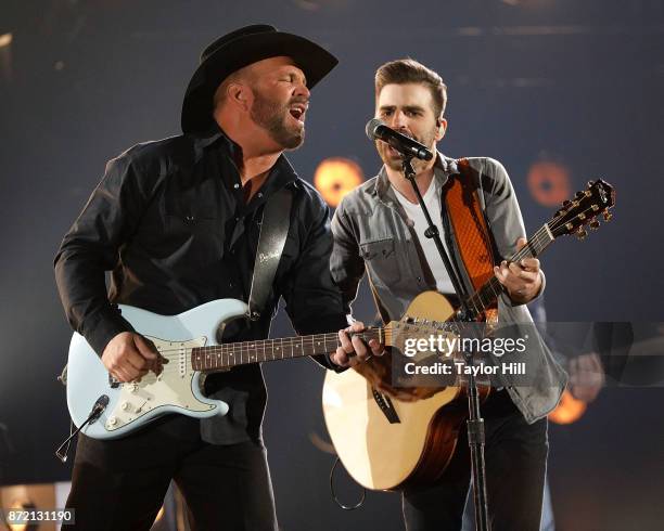 Garth Brooks and Mitch Rossell perform during the 51st annual CMA Awards at the Bridgestone Arena on November 8, 2017 in Nashville, Tennessee.