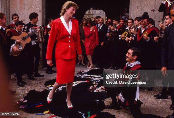 Musicians in Salamanca, Spain drape their cloaks in front of Princess Diana as a mark of respect, on April 23, 1987. She Is wearing a dress designed...