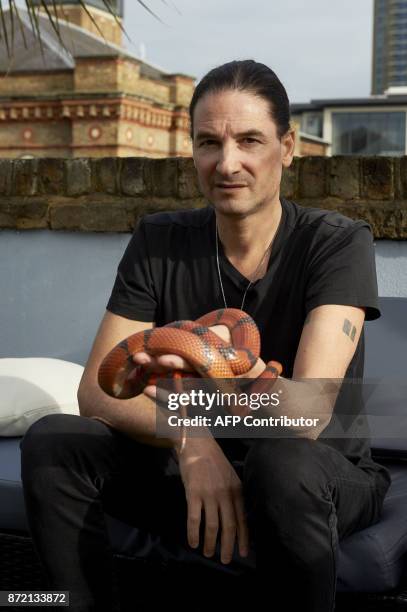 Steve Ludwin poses with a Honduran milk snake outside his apartment in Kennington, south London on November 9, 2017. For nearly 30 years, Steve...