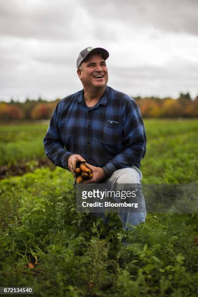 Farmer Jim Ward, owner of Wards Berry Farm, gathers carrots grown on his farm in Sharon, Massachusetts, U.S., on Tuesday, Oct. 24, 2017. An ex-banker...