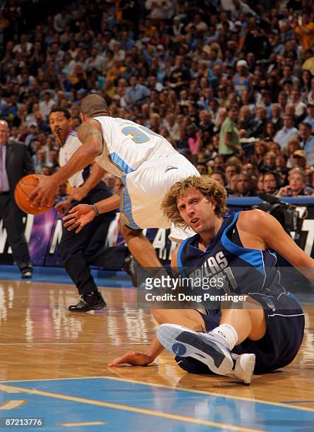 Dirk Nowitzki of the Dallas Mavericks hits the floor after having the ball stolen by Dahntay Jones of the Denver Nuggets in Game Five of the Western...