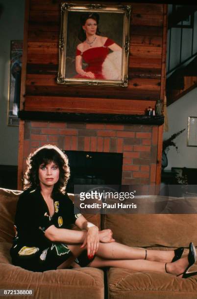 Lana Wood, Natalie Woods sister sister photographed at home with a portrait of Natalie on the wall November 17, 1991