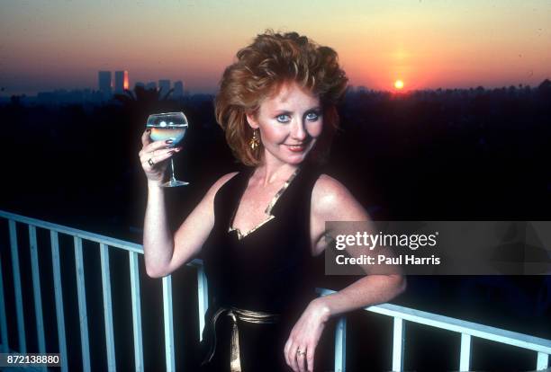 Lulu the English singer enjoys a glass of wine on a balcony at the St James Club, May 5, 1991