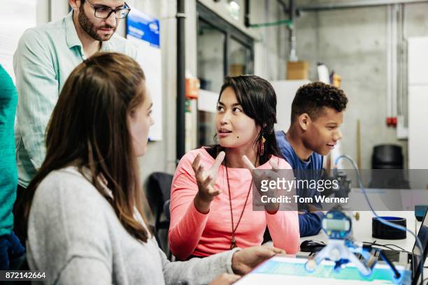 student explaining their lab experiment to tutor - educational establishment stock pictures, royalty-free photos & images