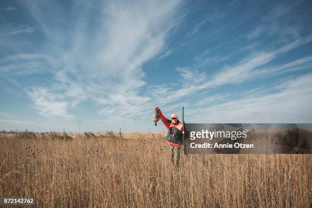 man proudly holds up a pheasant - chasing tail stock pictures, royalty-free photos & images