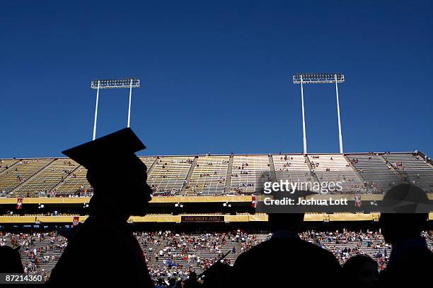 Arizona State University graduate students are silhouetted during their graduation at Sun Devil Stadium May 13 in Tempe, Arizona. US President Barack...