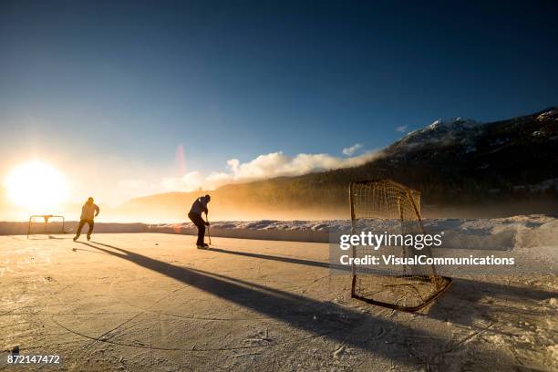 whistler, bc: pond hockey on alta lake. - pond hockey stock pictures, royalty-free photos & images