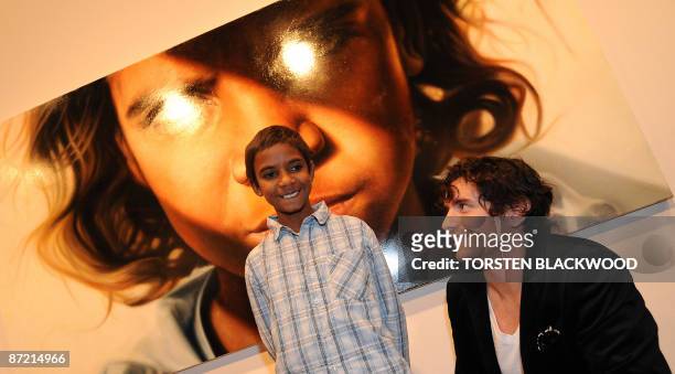 Australian artist Vincent Fantauzzo looks up at his muse after his striking portrait of Aboriginal child actor Brandon Walters won the 2009 Archibald...