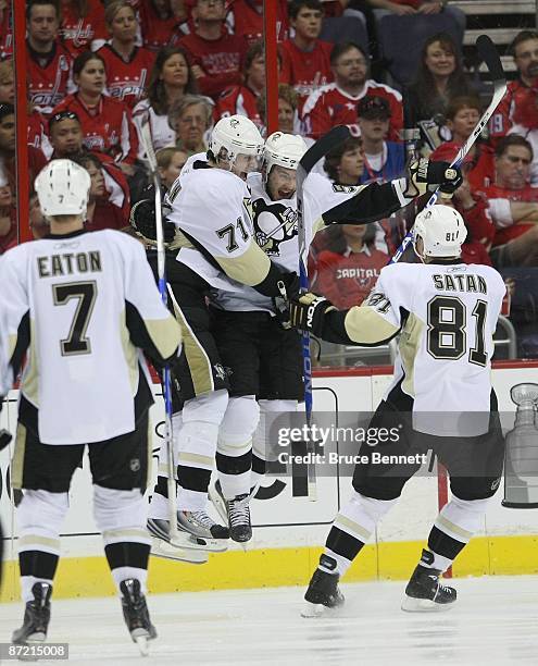 Evgeni Malkin and Kris Letang of the Pittsburgh Penguins celebrate Letangs goal at 10:13 of the second period against the Washington Capitals during...