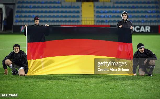 Children hold the German flag prior to the UEFA Under21 Euro 2019 Qualifier match between Azerbaijan U21 and Germany U21 at Dalga Arena on November...