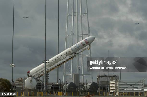 The Orbital ATK Antares rocket, with the Cygnus spacecraft onboard, is raised into the vertical position on launch Pad-0A, Thursday, November 9, 2017...