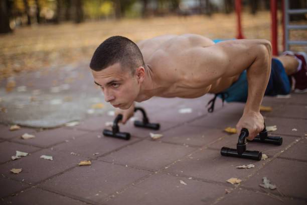 push-ups outdoors - push up bars stock pictures, royalty-free photos & images