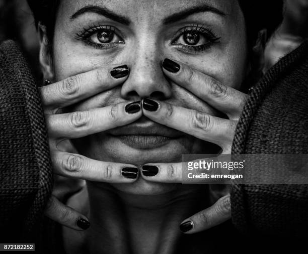 portrait of woman holding face in hands, toned - emreogan stock pictures, royalty-free photos & images