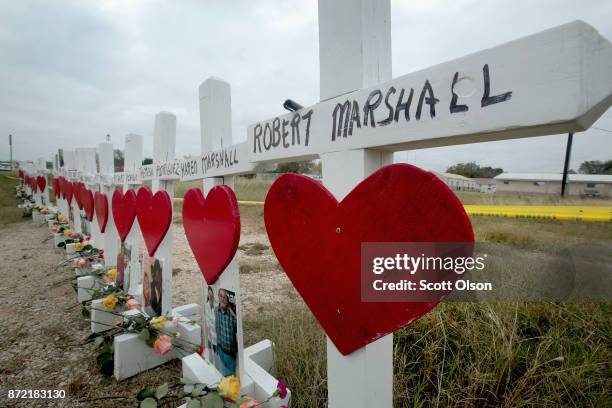 Twenty-six crosses sit just outside crime scene tape along Highway 87 near the First Baptist Church of Sutherland Springs to honor the 26 victims...