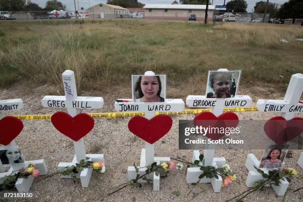 Twenty-six crosses sit just outside crime scene tape along Highway 87 near the First Baptist Church of Sutherland Springs to honor the 26 victims...