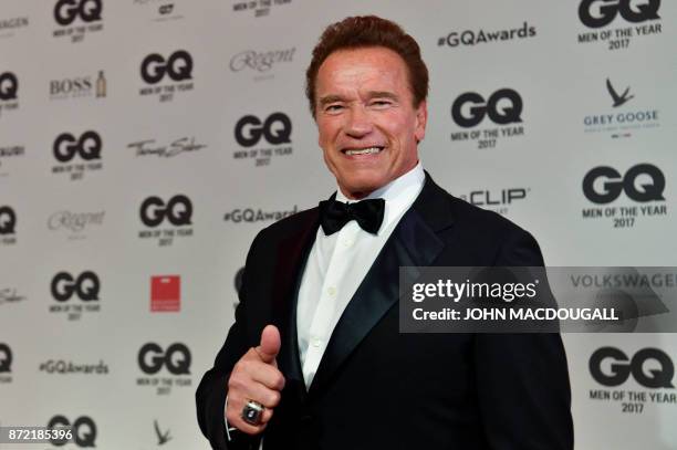 Actor and former California governor Arnold Schwarzenegger poses on the red carpet as he arrives for the GQ "Men Of The Year" awards ceremony in...