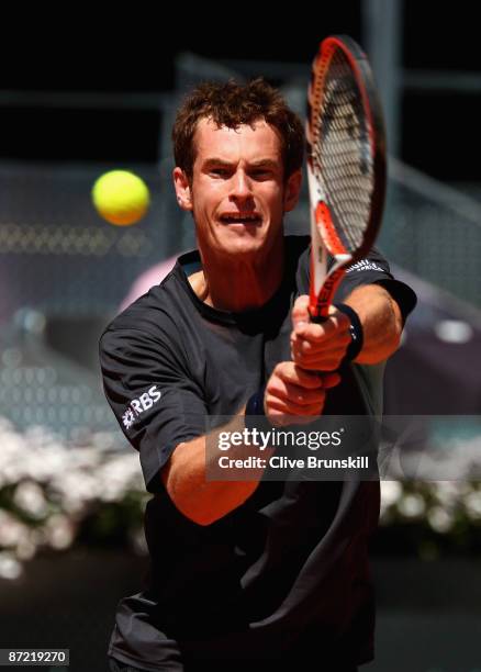 Andy Murray of Great Britain plays a backhand against Tommy Robredo of Spain in their third round match during the Madrid Open tennis tournament at...