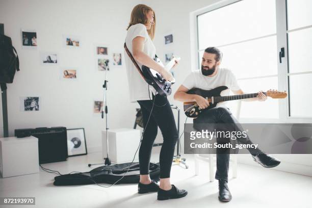 couple making music - woman in guitar making studio stock pictures, royalty-free photos & images