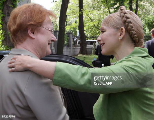 Ukraine's Prime Minister Yulia Tymoshenko embraces Finnish President Tarja Halonen during a parting ceremony after the talks in Kiev on May 14, 2009....