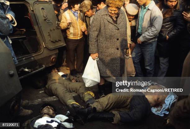 Three dead members of Ceausescu's security team lie in the town centre of Bucharest during the Romanian Revolution, December 1989.