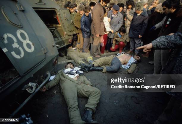 Three dead members of Ceausescu's security team lie in the town centre of Bucharest during the Romanian Revolution, December 1989.
