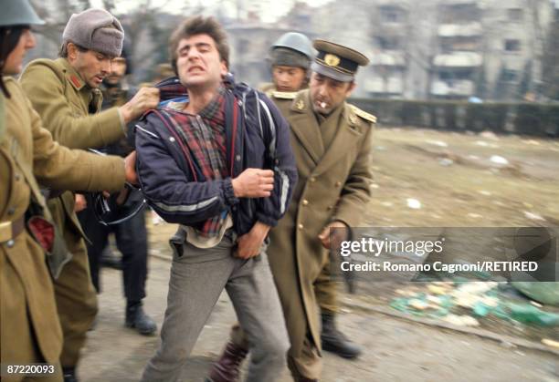 Known collaborater with the Ceausescu regime is picked up by soldiers in Timisoara during the Romanian Revolution, December 1989.