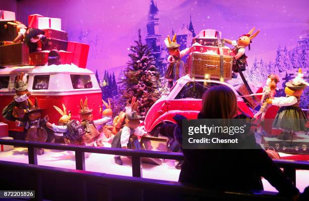 Child looks at the Christmas window display of the "Le Printemps Haussmann" department store after the inauguration of the store's illuminations for...