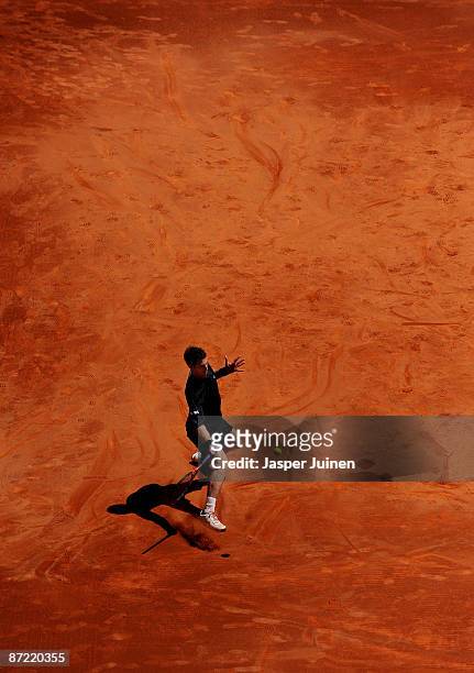 Andy Murray of Great Britain slides to play a backhand to Tommy Robredo of Spain in their third round match during the Madrid Open tennis tournament...