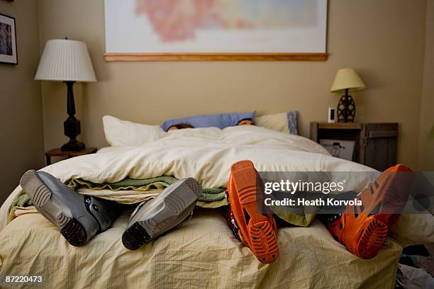 two skiers sleep with ski boots on. - skischoen stockfoto's en -beelden