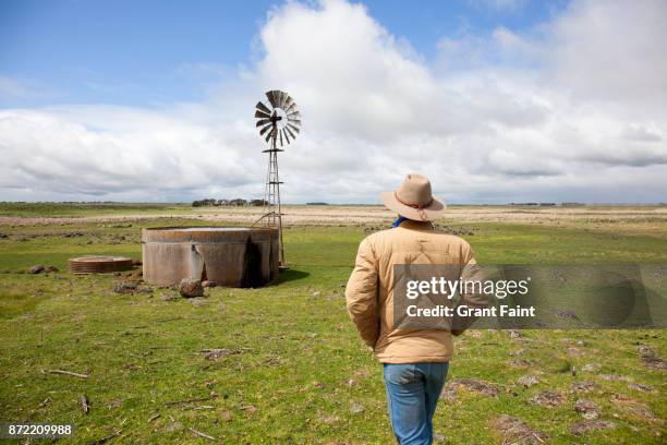 sheep farmer checking his water tank. - farmer australia ストックフォトと画像