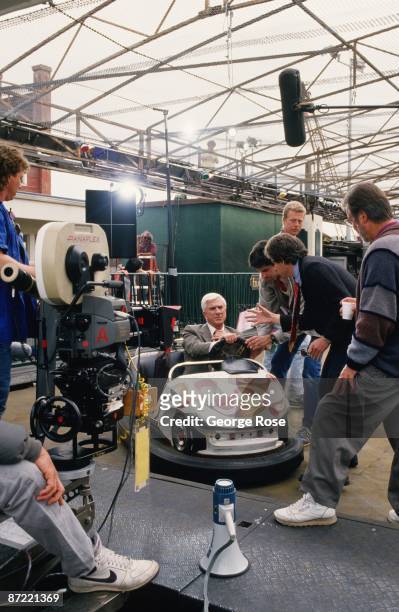 Actor Leslie Nielsen sits in an amusement park bumper car during the 1988 Santa Monica, California, filming of the comedy movie "The Naked Gun."