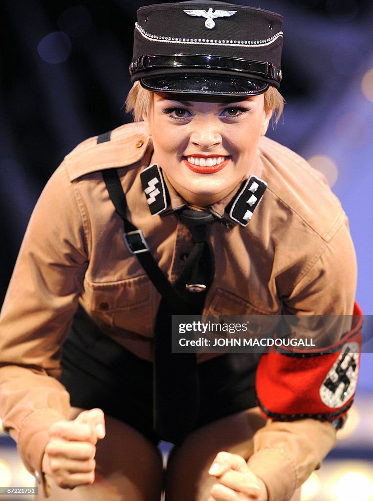 A dancer dressed as a Nazi SS officer pe