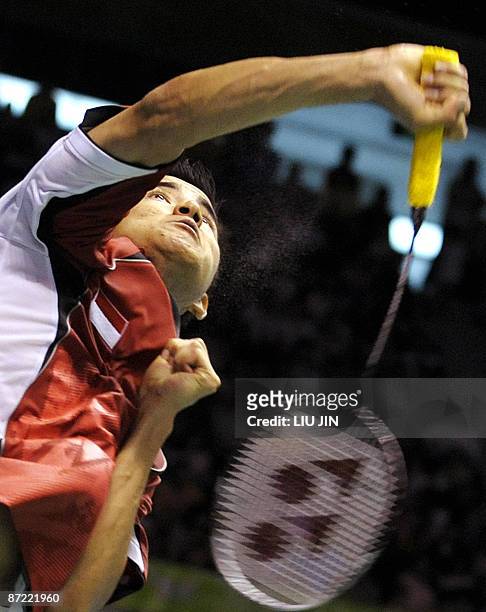 Indonesia's Simon Santos smashes a shuttlecock against China's Lin Dan during the men's singles preliminary match at the Sudirman Cup World Team...
