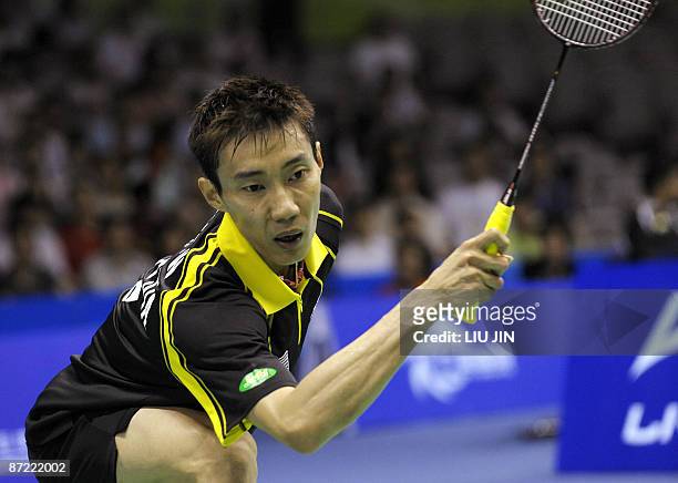 Malaysia's Lee Chong Wei competes against Denmark's Jan O Jorgensen during the men's singles preliminary match at the Sudirman Cup World Team...