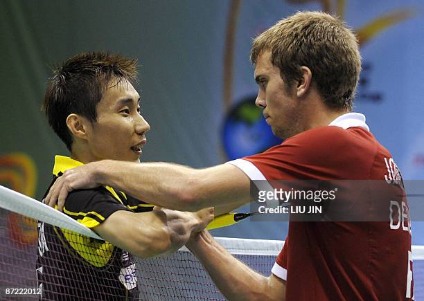 Malaysia's Lee Chong Wei shakes hands with Denmark's Jan O Jorgensen during the men's singles preliminary match at the Sudirman Cup World Team...
