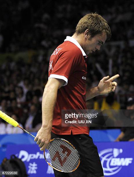 Denmark's Jan O Jorgensen reacts to a losing point against Malaysia's Lee Chong Wei during the men's singles preliminary match at the Sudirman Cup...