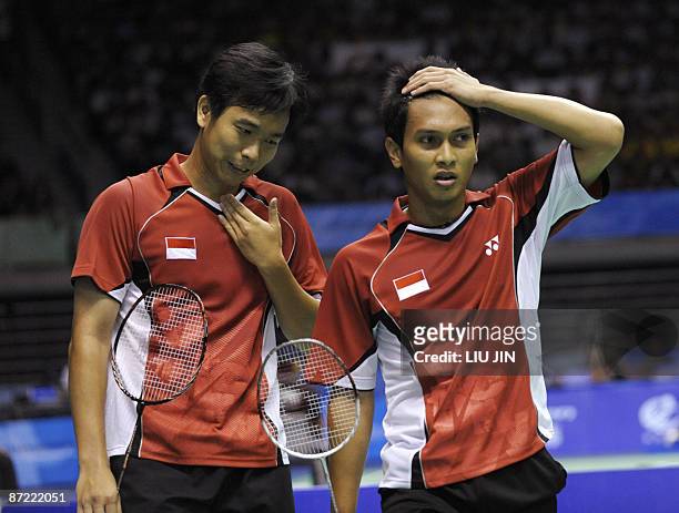 Indonesia's Hendra Setiawan and Mohammad Ahsan react to a losing point against China's Cai Yun and Fu Haifeng during the men's doubles preliminary...