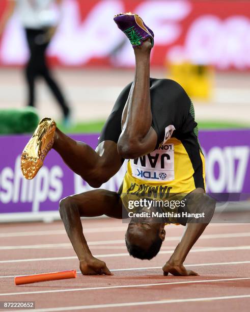 Usain Bolt of Jamaica falls to the track in the Men's 4x100 Relay final during day nine of the 16th IAAF World Athletics Championships London 2017 at...