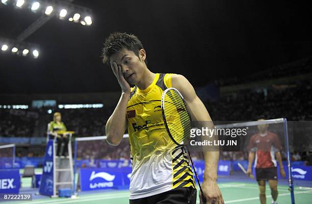 China's Lin Dan wipes sweat from his face during the men's singles preliminary match against Indonesia's Simon Santoso at the Sudirman Cup World Team...