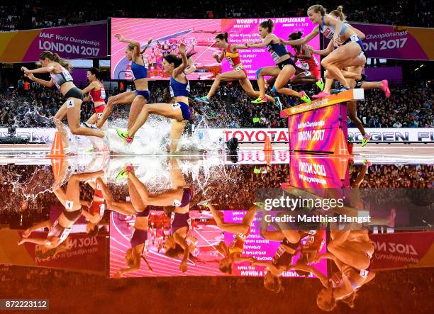 Lennie Waite of Great Britain and others jump the hurdle at water jump as they compete in the Women's 3000 metres Steeplechase heats during day six...