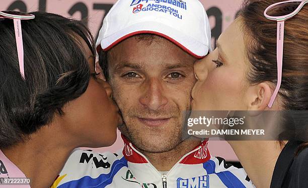 Italy's Michele Scarponi is kissed by two beauties on the podium of the sixth stage of 92nd Giro of Italy between Bressanone and Mayrhofen im...