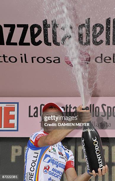 Italy's Michele Scarponi celebrates with champagne his victory on the podium of the sixth stage of 92nd Giro of Italy between Bressanone and...