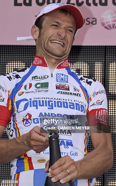Italy's Michele Scarponi grimaces as he celebrates his stage's victory on the podium of the sixth stage of 92nd Giro of Italy between Bressanone and...
