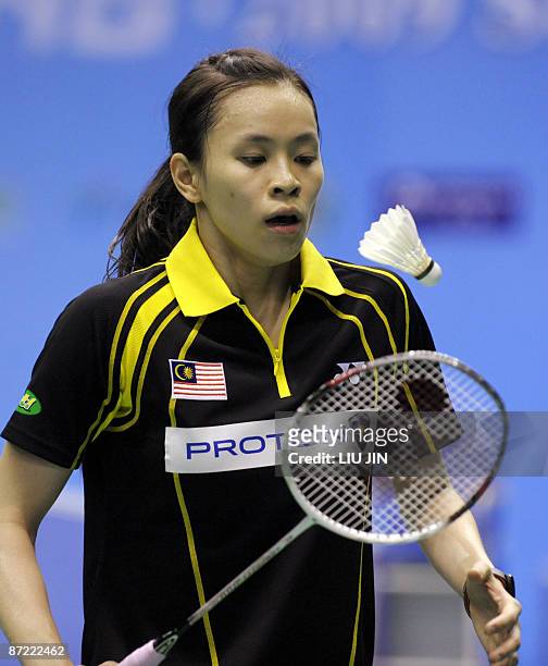 Malaysia's Wong Mew Choo prepares to serve a shuttlecock against Denmark's Nanna Brosolat Jensen during the women's doubles preliminary match at the...