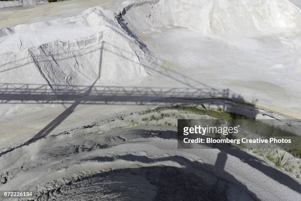 the shadow of a conveyor is cast on a stockpile of lithium ore - oceana stock pictures, royalty-free photos & images