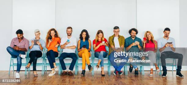 people using modern technology - medium group of people stock pictures, royalty-free photos & images